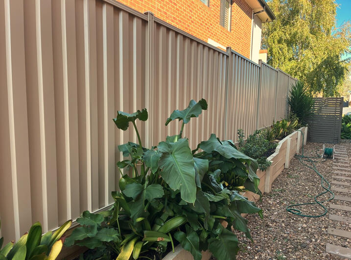 Colorbond Fence with Timber Sleepers Installation in Berwick Colorbond fence Paperbark with timber sleepers installed in Berwick